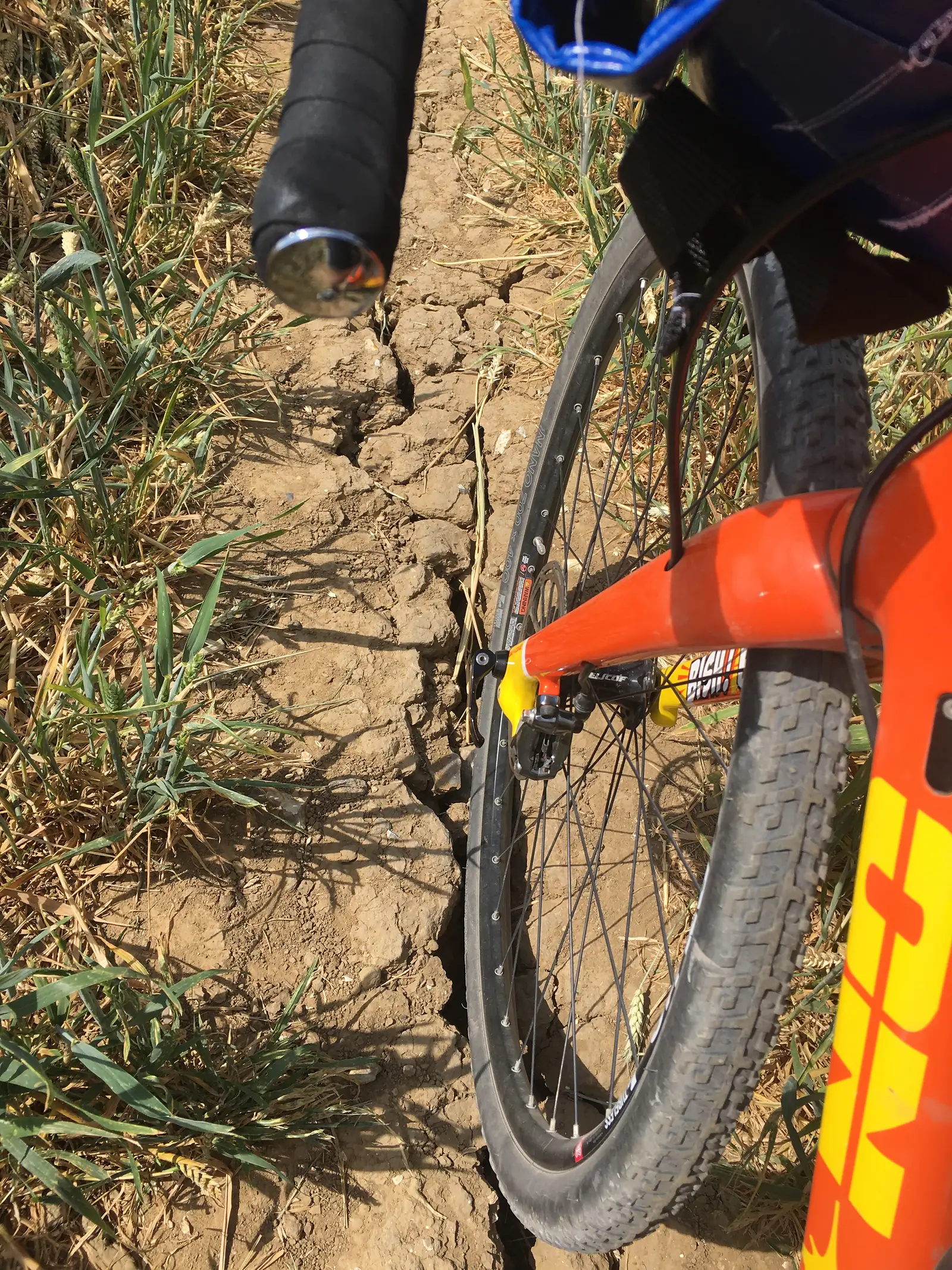 Massive crack in a field with a bike tyre stuck in it