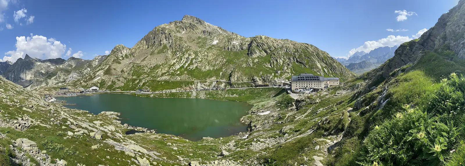 Moutain vista looking over the lake and buildings at Col du Grand St Bernard.