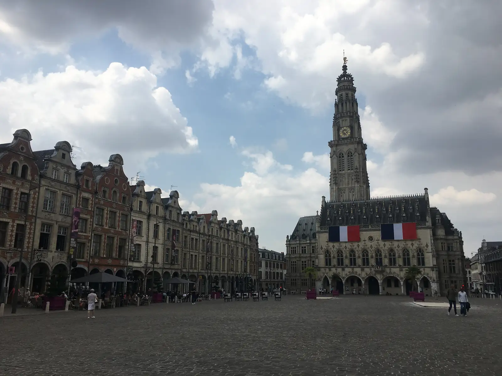 Arras's Place des Héros, its ornate gabled Flemish townhouses lining a cobbled square beside the belfry of the town hall, hung with French tricolour flags.