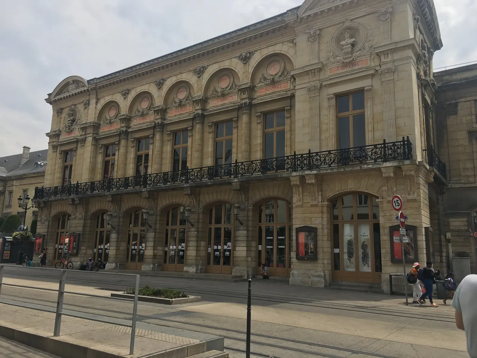 The ornate stone facade of the Grand Théâtre in Reims, its arched windows topped with medallions naming Mozart, Molière and other playwrights and composers.